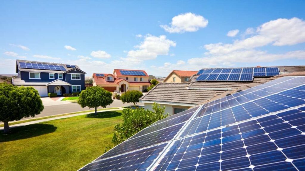 USA residential neighborhood with multiple home rooftops installed with solar panels, showcasing solar energy clean energy systems across American houses.